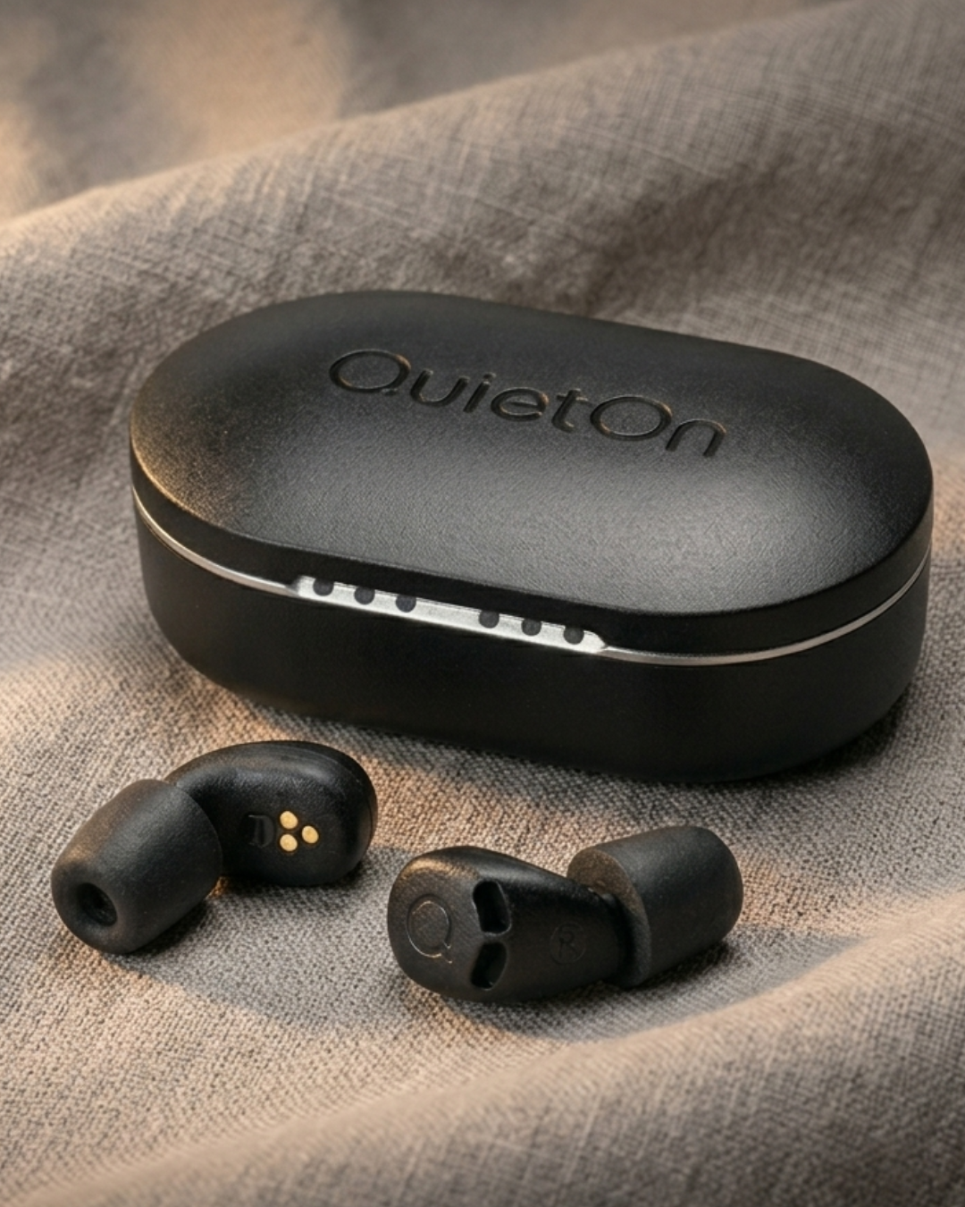 QuietOn 4 sleep earbuds and charging case, matte black with memory foam tips — designed for a calm, undisturbed night's sleep.